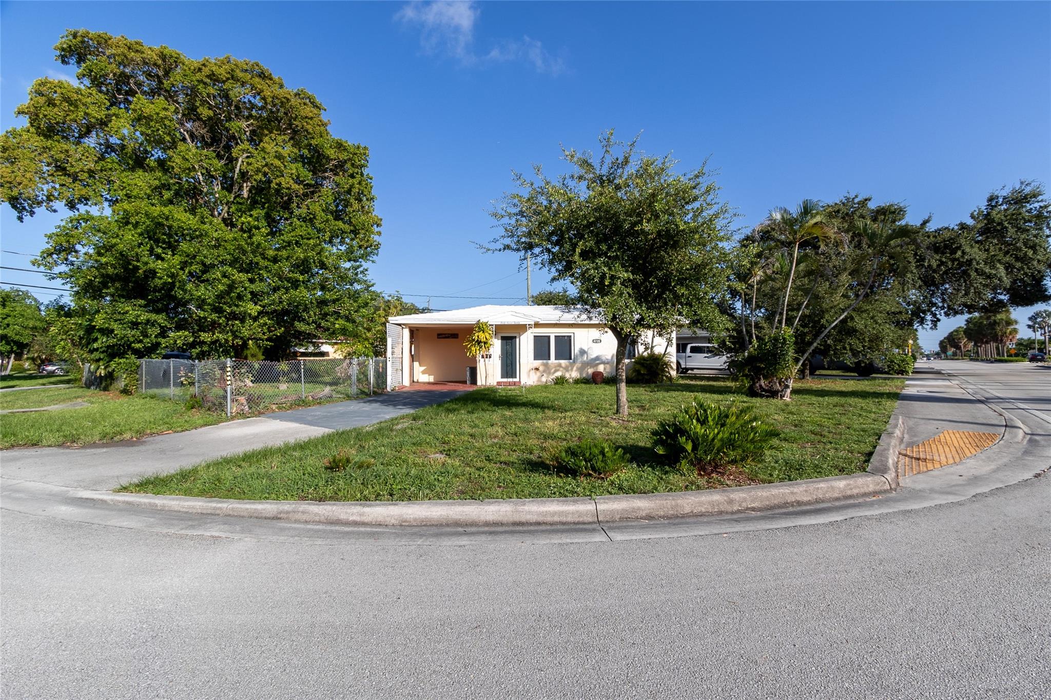 This charming, well maintained single story home sits on an oversized, fenced-in corner lot (7,341 sq ft) providing easy access to the spacious backyard with ample room for a pool and additional space for parking a boat or RV. Features include Impact Windows and Doors, a large, private Florida Room, Terrazzo floors, updated kitchen, Carport, New Central A/C, Utility Room with W/D hookups and space for additional storage, updated sewer. Conveniently located between Prospect and Commercial Blvd this home is only 3.4 miles to beaches in Lauderdale By The Sea and even closer to area shopping, highways, rail transportation, medical facilities, schools and Airports. Concrete tile roof professionally cleaned and sealed annually. Sprinkler system on well water. No HOA and No Rental Restrictions.
