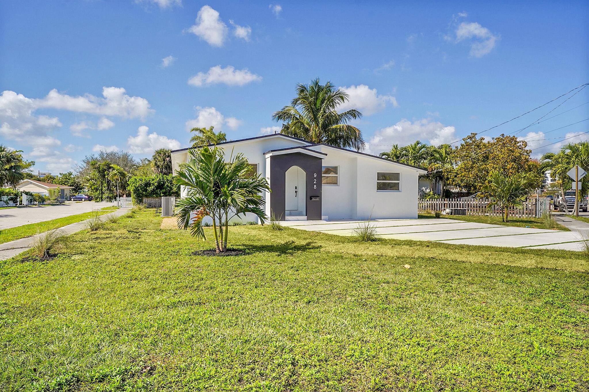 Beautiful, luxurious designed single-family home located five mins from vibrant downtown WPB. This complete interior and exterior remodel embodies a 2024 central A/C system, a new roof, and custom impact windows with premium LED soffit lights. Elaborate, bright living room featuring new tile flooring and that enhances the sense of space. This custom made kitchen is equipped with top of the line Samsung Bespoke appliances, a waterfall Quartz center island, and elegant white cabinetry with stylish pendant lighting. The outdoor space includes a patio, ideal for entertaining or enjoying a quiet evening. This turnkey home is personally crafted with a layout that is the perfect blend of a premium comfort with the convenience of location and proximity to i-95 and the beach.