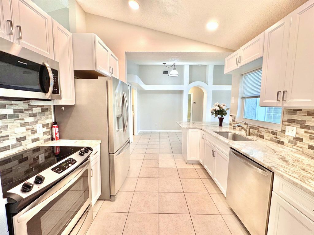 Photo of 2349 SE Leithgow Street, Port Saint Lucie, FL 34952 (MLS # R11023192)