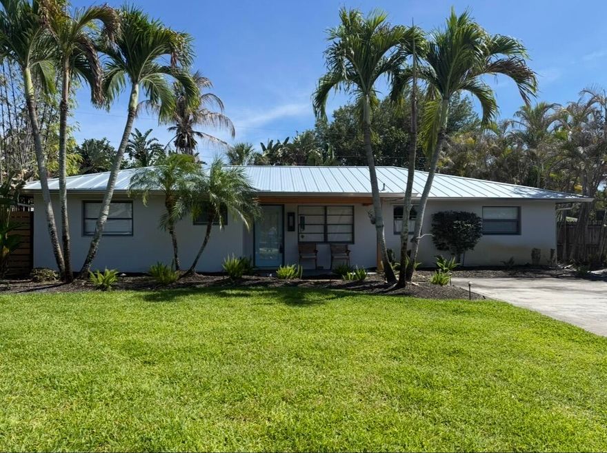 Beautifully renovated 3-bedroom, 2-bath CBS home blending classic Florida charm with stylish modern updates, including a brand-new A/C installed in 2024. Set well back from the road, this unique property offers exceptional privacy along with an oversized concrete driveway accommodating up to six vehicles. There's also plenty of side yard space for boat storage and room to add a pool.    Inside, wide-plank engineered oak hardwood flooring runs throughout the home, creating a warm and upscale feel. The open-concept living area is ideal for entertaining, while the distinctive faux brick fireplace serves as a charming focal point shared between the spacious living room and separate dining area. The dining room also features stunning pecky cypress ceilings that add character. New roof!