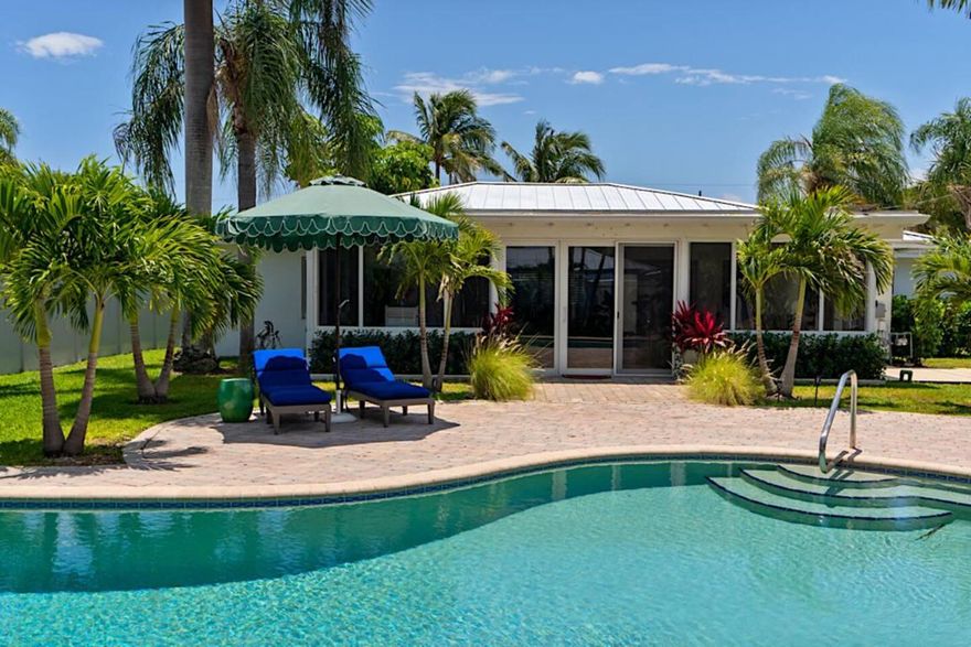 Sunny Bermuda style one story house with open floor plan one block from intracoastal in the heart of the College Park neighborhood in Lake Worth Beach. Spacious 3 bdrm/2 bath completely renovated, including metal roof, complete impact windows and doors, updated appliances and tankless water heater.  Large windows and doors provide natural light throughout, opening to saltwater, free-form pool and patio, in private, fully fenced stylishly landscaped backyard.  Just minutes away from golf, beaches, restaurants and culture.