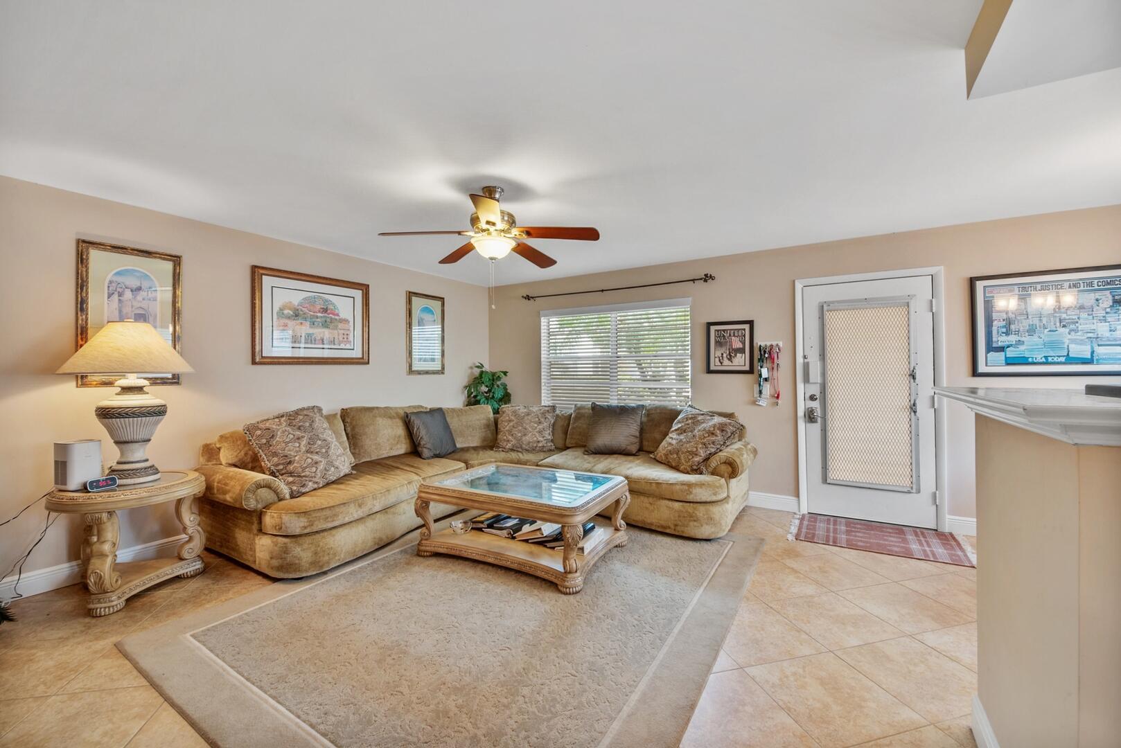 Welcome to this light-filled, move-in-ready 2-bedroom, 2-bath condo located on the desirable first floor in the vibrant Kings Point community. This home features an open floor plan with neutral flooring throughout, no carpeting, creating a modern, cohesive look that's both stylish and low maintenance. The updated kitchen is a standout, showcasing classic white cabinetry, a chic tiled backsplash, sleek stainless-steel appliances, and ample counter space, perfect for entertaining or everyday living. The spacious primary suite offers a private retreat with a walk-in closet, ensuite bath with a walk-in shower, and French doors that open directly onto the enclosed, air-conditioned patio. The second bedroom also has access to the patio, making it ideal for guests or a home office.
