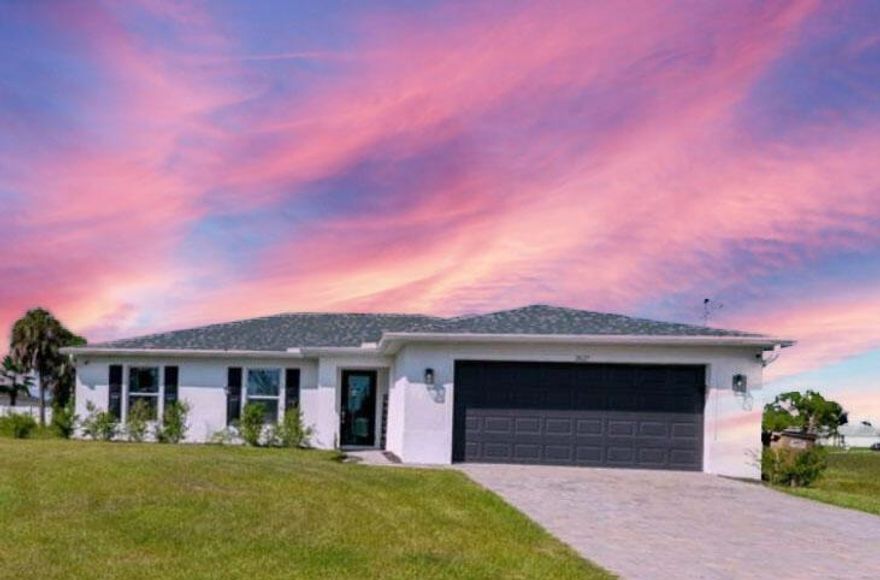 Discover the perfect blend of style, space, and functionality in this beautifully maintained 4-bedroom, 2-bath home located in the fast-growing Northwest Cape Coral neighborhood. From the moment you step through the glass-paneled front door, natural light floods the open-concept layout, highlighting the soaring vaulted ceilings and spacious great room that unites the kitchen, living, and dining areas.The kitchen is built for both everyday living and entertaining, with stainless steel appliances, a large island with breakfast bar seating, and a sleek touchless faucet. Just off the living room, sliding glass doors lead to a covered lanai and extended deck ideal for grilling, dining, or simply enjoying the Florida breeze.