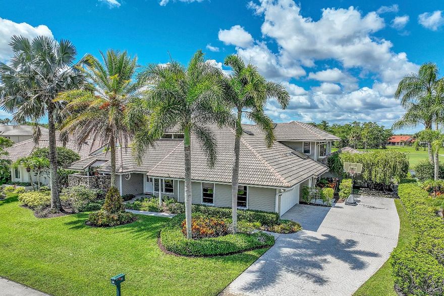 Space for days! Soaring ceilings in this enormous, sunny, bright waterfront 6-bedroom/3.5-bath, pool home in the coveted Marlwood Estates in PGA. This rare find will accommodate large & extended families with room to spare. Beautiful first floor primary bedroom suite on one side of the home & a separate wing on the opposite, housing 5 additional bedrooms; one with potential for a studio apt. The open-concept floor plan has wide-plank flooring, a vaulted ceiling with skylights, & French doors leading to a covered lanai & saltwater pool with waterfall & serene waterfront & golf course views. Massive spa-like pool area for entertaining, already plumbed for a summer kitchen! Airy Formal & Family rooms, Dining Room, & massive open granite kitchen with water views. Tons of counter & storage. Bright breakfast nook has modern lighting, skylight, and a backyard view. 1st floor primary bedroom has his and hers walk-in closets with built-ins, and private entry to the pool through French doors. The atrium-like primary bath has his and hers vanities with marble countertops, a separate water closet, a separate glass-enclosed shower, and a sunken tub. All 5 additional bedrooms have hardwood floors & both 2nd-floor bedrooms have charming seated bay windows and beautiful views. Large mud room has two entrances, from garage & exterior, with large capacity HE LG washer/dryer, utility sink, and storage cabinetry. This picturesque move-in ready Sabatello-built estate is waterfront with views of the 8th hole of the PGA Match golf course; has Northern Front exposure and back exposure facing South. The home has 4 A/C units, 2 water heaters, and an Impact garage door. The covered lanai has tongue & groove ceiling and skylight. Side-entry two-car garage and enormous stamped concrete driveway can accommodate multiple additional cars. Home is professionally landscaped with majestic palms. Marlwood Estates in PGA National is convenient to walking trails, parks and recreation. Memberships are available for resort style living including, world class golf, tennis, pickleball, fitness, spa and fine dining--incredible home, location and community.