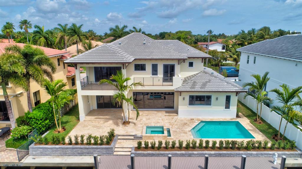 $300,000 PRICE REDUCTION!! Be the first to live in this modern, chic, waterfront oasis in the highly desirable neighborhood of Boca Harbour. This newly constructed Southern exposure estate home with an open floor plan features five bedrooms, five full bathrooms, an expansive gourmet kitchen with solid wood cabinets, large island, quartz countertops, Wolf Sub-Zero appliances, and a gas cooktop. All bathrooms have been professionally designed with high-end porcelain and ceramic tile and quartz vanities. Additional interior features include hardwood flooring throughout, level 5 smooth ceilings, recessed LED lighting, CGI impact windows, and doors, casing around all windows, first and second floor laundry rooms, 6' baseboards, & high-end fixtures.