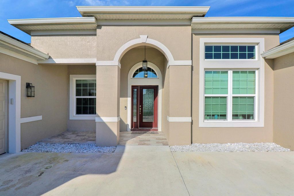 Photo of 1910 SW Mackenzie Street, Port Saint Lucie, FL 34953 (MLS # R10967482)