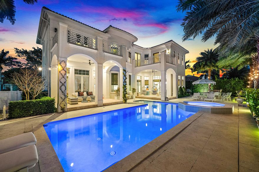 Welcome to this exceptional Ocean Ridge Waterfront Gem. This turnkey and completely renovated deepwater estate sits on a private lot with 100 feet of deep water-frontage on a wide 95-foot canal, offering direct boating access with no fixed bridges to the ocean and the ultimate South Florida lifestyle. Blending timeless Mediterranean architecture with Coastal modern upgrades, the home welcomes you with a dramatic 25-foot entry, soaring 14-foot ceilings, refined millwork, elegant archways, and expansive light-filled living spaces framed by hurricane-impact glass that capture stunning water views from nearly every room. The open-concept chef's kitchen is designed for entertaining and everyday living, featuring premium Wolf, Sub-Zero, and Miele appliances, an oversized island, countertops, walk-in pantry, and seamless flow into the main living and dining areas. Since purchasing, the owners have thoughtfully renovated throughout, including new flooring, a fully updated kitchen, remodeled bathrooms, pool and tile upgrades, custom built-in closets, and a luxurious 2024 primary bath finished in marble with a jetted soaking tub, while additional improvements include new A/C units (2025), new washer and dryer (2025), garage organizer systems, and a gas line available for future connection. The primary suite offers vaulted tray ceilings, spa-inspired finishes, and a private balcony overlooking the water, creating a true retreat. Outdoors, multiple covered loggias, expansive terraces, and a resort-style heated pool and spa are surrounded by lush tropical landscaping, delivering exceptional privacy and the feel of a boutique waterfront resort. Located in the quiet, highly desirable seaside community of Ocean Ridge with deeded beach access and just minutes from Delray Beach's dining and shopping, this move-in-ready waterfront residence offers luxury, location, and effortless coastal living all in one.