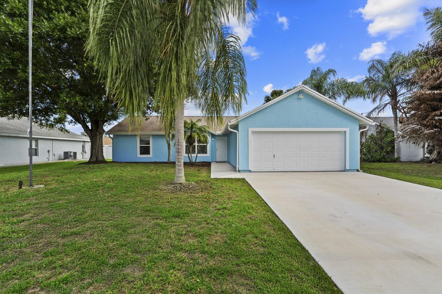Welcome to 243 SW Aubudon Ave in the heart of Port Saint Lucie—offering a bright, open layout with functional, easy living spaces. The centrally located kitchen features ample cabinetry and flows seamlessly into the main living areas, perfect for both everyday living and entertaining. Enjoy a split floor plan with comfortable sized bedrooms, including a private primary suite filled with natural light. Step outside to a spacious backyard with a covered gazebo and storage shed—plenty of room to relax, entertain, or even add a pool. Situated in a quiet neighborhood with no HOA, this home offers both flexibility and convenience, just minutes from shopping, dining, parks, schools, and major roadways. Buyers will have a piece of mind with Impact Windows/Doors and a 2024 roof!