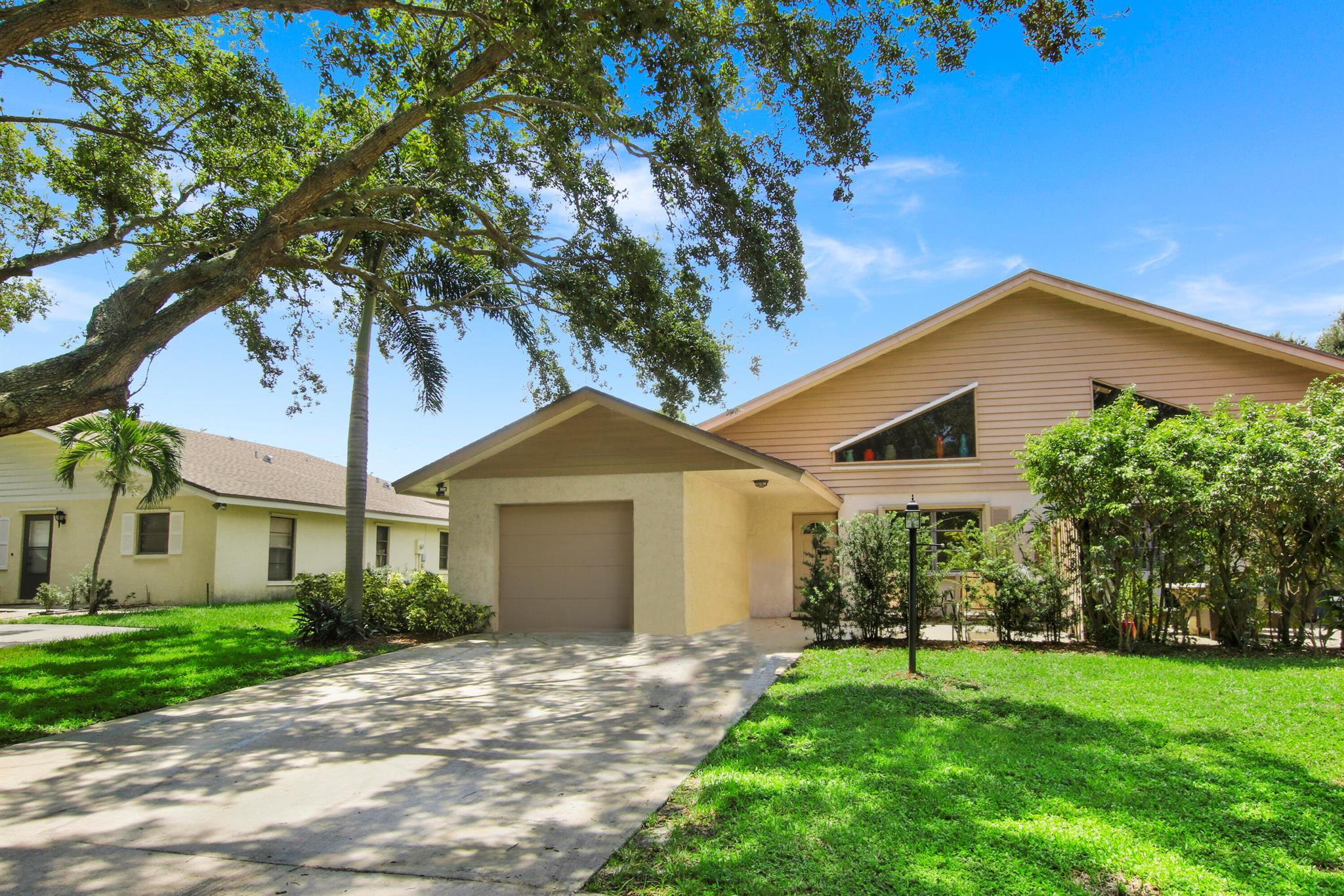 This open floor-plan 3B 2B high ceiling townhome on quiet no-pass through tree-lined lane is a gem in unincorporated North Palm Beach! High ceilings add space and light yet the open floor plan is cozy! Open cook's kitchen with pantry, plenty of storage space, and snack bar overlooks dining area and living area which is great for entertaining. Primary bedroom with ensuite bathroom has private door to fenced in yard. Guest room is across the hall with full bath in between. Spacious upstairs bedroom with high ceilings and private balcony is a great space for an office or studio or can be a great multiple kid's bedroom. The screened in porch has full laundry room attached for convenience. Close to shops, pubs, and restaurants! Easy access to PGA Blvd, I-95, and turnpike. Close to beaches!