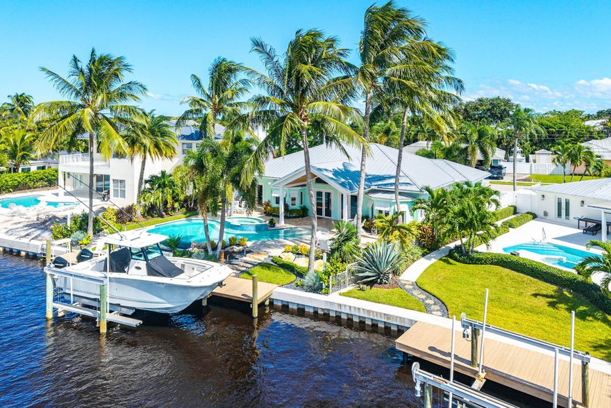 Experience the perfect blend of coastal charm and modern luxury in this stunning 4-bedroom, 3-bath CBS Key West-style home in the heart of Jupiter. Beautifully renovated with soaring vaulted and coffered ceilings, Bahamian-style fans, and an abundance of natural light, this residence radiates warmth, character, and effortless tropical living.
The bright, open kitchen showcases white wood cabinetry, quartz countertops, stainless-steel appliances with gas oven, and a cozy built-in breakfast nook overlooking the sparkling pool. Enjoy a private split floor plan and refined finishes throughout - plantation shutters, crown molding, recessed lighting, and custom shades. Step through French doors to the vaulted, covered patio with a tongue-and-groove cypress ceiling- the perfect setting... more: for outdoor entertaining. Relax by the heated infinity-edge pool and spa surrounded by lush palms and vibrant tropical landscaping.
With 70' of water frontage, a 50' dock with 16,000-lb lift, and no fixed bridges to the ocean, this home is a true boater's dream. Additional highlights include impact windows, a metal roof, dual A/C zones with Nest thermostats, a security system with cameras, a pristine 2-car garage, and a circular paver driveway.
Ideally located on a quiet street near the canal entrance with views of the Loxahatchee River  and no HOA  this home offers proximity to Jupiter's best restaurants, marinas, shops, pristine beaches, and the Jupiter Inlet. Within the top-rated Palm Beach County school district and convenient to PBI Airport.
Furnishings are negotiable, featuring upscale coastal-contemporary décor. A true tropical retreat with ocean access  enjoy the best of Jupiter's vibrant waterfront lifestyle!