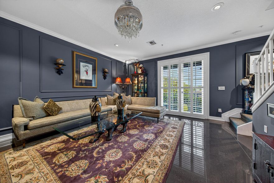 Live in the heart of vibrant Wilton Manors! This stylish, and meticulously maintained tri-level townhome offers it all. Sleek porcelain tile throughout, artistic wall moldings, Plantation Shutters, crown molding, tasteful lighting & ceiling fans. Spacious, open main living area w/ beautifully updated, and fully appointed chefs kitchen w/ Viking Stove, quartz counters, bar seating, plenty of storage, and elegant formal dining. Huge primary suite, w/ finished walk-in closets, luxurious bath, and a second ensuite bedroom w/ same floor laundry. Ground floor den/workspace/bedroom, and full two car garage. Complete impact windows and doors, new A/C & HWH. Community is pet friendly, and offers a tranquil courtyard style pool area. Professionally managed and well financed complex. A must see!