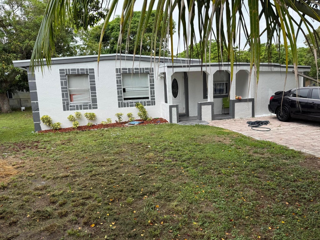 Photo of 440 Tulip Tree Drive, Lake Worth, FL 33462 (MLS # B26045930)