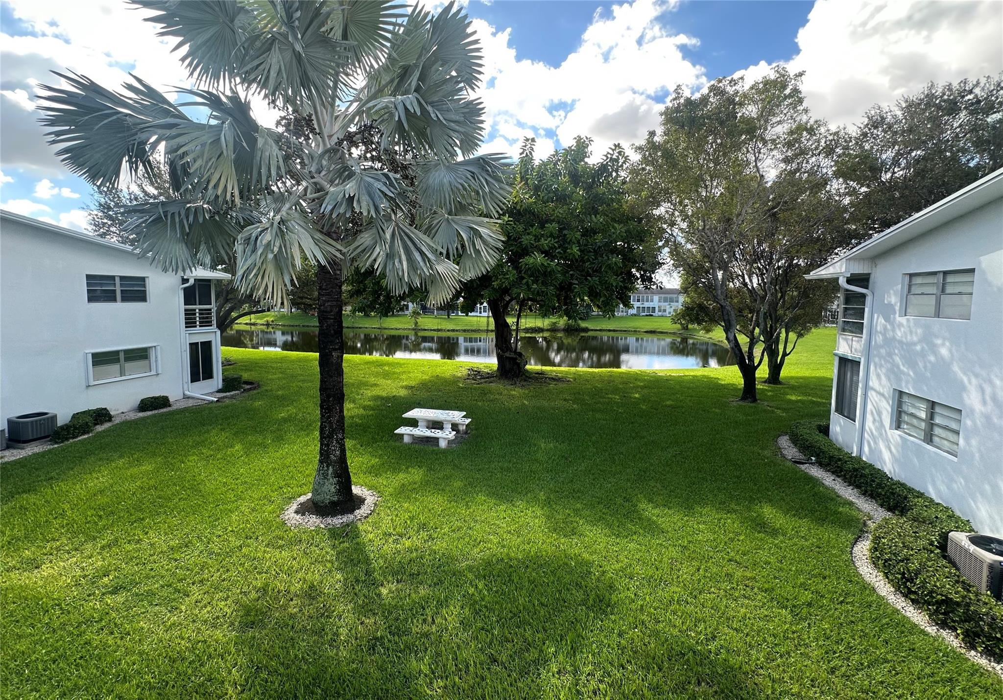 Bright REMODELED, CORNER 1 Bedrm, 1.5 bath condo on the 2nd flr w/a beautiful view of the water from liv rm. Lovely open kit concept features grey shaker cabs, granite cntrs w/lg. island for entertaining, new dishwasher & recessed lts. Many upgrades incl. HURRICANE IMACT FRONT DOOR & WINDOWS for added security, laminate flrs, NEW ELECTRICAL PANEL, A/C 3 yrs old, knockdown on ceilings in liv area & an encl patio. Gorgeous shower stall w/rain shower head, glass doors & tile walls. Unit is FURNISHED incl an $8K electric bed for extreme comfort! This active adult gated comm has 24 hr security, courtesy bus, pools, tennis, pickle ball, putting green, lavish clubhouse w/fitness cntr, cafe, theater, free movies, classes, clubs, billiards & more! Close to shops, dining & beach!  ASSOC. CLAIMS 55+