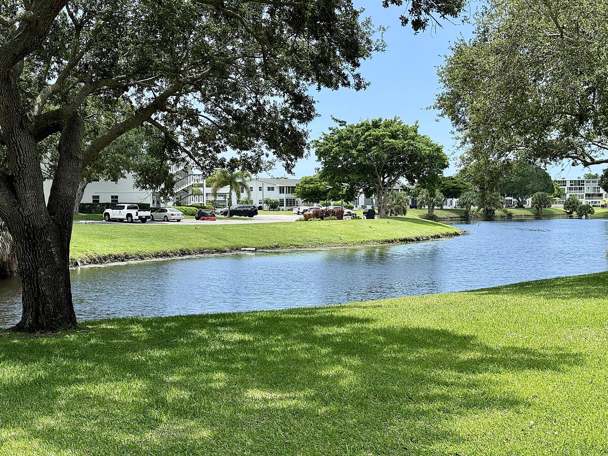 First Floor Lake View from enclosed titled patio. . Partially Furnished or Unfurnished 1 BR/1.5 Baths. Lovely renovated Galley Kitchen with high hat lighting, Granite Counters, Title Backsplash, SS Farm Sink and SS Appliances. Title & Laminate Flooring. Updated baths and walk-in shower in main bathroom. Stepts from the Newport Community pool+tennis. Clubhouse has indoor+outdoor pools, cafe, 1600 seat theater, clubs, tennis, billiards, pickleball, volleyball, ping pong, bocce, shuffleboard, fitness center, hiking+bike trails, putting green. Close to beaches, entertainment, dining, shopping. 55+ age
