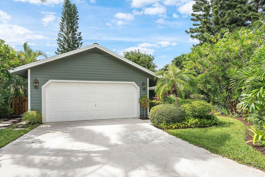 A Tropical Sanctuary in the Heart of Tequesta Tucked away at the end of a quiet lane, this captivating 3-bedroom, 2-bath residence offers the perfect blend of privacy and sophistication. A soaring ceiling welcomes you into sunlit, open living spaces including a gracious living room, intimate family room, and an inviting master suite with dual vanities, walk-in closet, and spa-inspired bathroom. The chef's kitchen is beautifully appointed with granite countertops, top-tier stainless appliances,  light maple cabinetry, complemented by a breakfast bar and adjoining dining area adorned with rich 5/8'' Merbau wood flooring also found throughout home. Designed for effortless indoor-outdoor living,  sliding doors open to a 43-foot coral patio shaded by a vine-covered pergola and framed by lush.