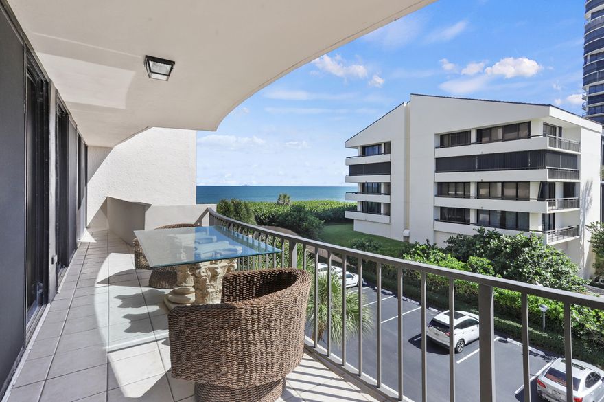 This stunning condo boasts an exquisite interior, featuring breathtaking ocean views from the main balcony and a picturesque pool view from the kitchen balcony. The living area is adorned with new ceramic tile flooring, while the master bedroom is equipped with impact plantation shutters, and all sliding doors are made of impact glass for added safety. The unit includes a brand new, top-of-the-line washer and dryer, along with the convenience of a private beach entrance and covered parking. Residents can enjoy access to a pool and tennis courts, all within a short five-minute drive to Riviera Beach, which offers a variety of restaurants and shops. Additionally, it is conveniently located near Sailfish Marina, where one can find a restaurant and a water taxi service to Peanut Island.