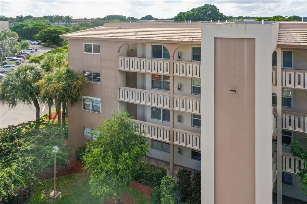 LIVE LIKE YOU’RE ON VACATION! Welcome to Wynmoor, an active 55+ community offering resort-style living. This top-floor corner unit is updated and ready to move in. Being a corner unit, it is filled with natural light & has an open, spacious feel. Enjoy a large updated eat-in kitchen w/ soft-close white shaker cabinetry, quartz countertops, stone tile backsplash & stainless steel appliances. Laminate flooring runs throughout, along w/ impact windows, updated bathrooms, recessed lighting, smooth ceilings, fresh white paint, washer/dryer in unit & a glass-enclosed patio. Wynmoor is an adult playground featuring a magnificent clubhouse, state of the art theater, pools, golf, fitness center, clubs/classes, tennis/pickleball, bus service & much more. Don’t miss your chance to call Wynmoor home!