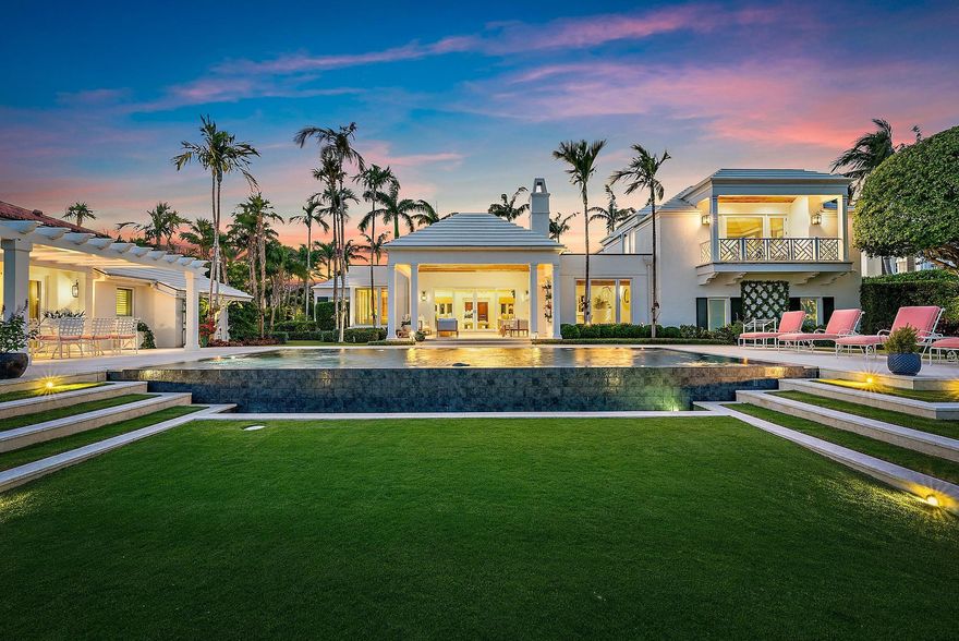 BEAUTIFULLY REIMAGINED: This Bermuda gem evokes an island lifestyle and ambiance which is ideal for families and entertaining. The interior has been beautifully reimagined and is now in total harmony with the tropical gardens that surround the house. The home is the epitome of ''Palm Beach Chic'' in the truest sense. Architectural elements include soaring pickled wood ceilings throughout the house, outdoor covered loggias with a fireplace and an infinity pool which all create a magical setting overlooking 150' of water frontage. There is a separate pool house positioned alongside the water which consists of a large living room with vaulted ceilings, bedroom, bathroom, morning bar and outdoor gazebo for ''alfresco'' dining. The house was taken down to the studs in 2016 and SEE MORE: