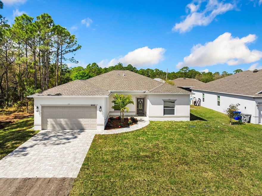 Brand-new Samara Model in Vero Lake Estates with the freedom of NO HOA. This CBS 3-bedroom, 2-bath home offers 1,729 sq ft under air with a bright open-concept design ideal for everyday living and entertaining. The spacious great room flows into the dining area and designer kitchen featuring quartz countertops, modern cabinetry, recessed lighting, luxury vinyl plank flooring, and a large center island perfect for gathering. Impact windows provide security and energy efficiency throughout. The split-bedroom floor plan offers privacy with a generous primary suite featuring dual vanities, walk-in closet, and a beautifully tiled shower. A huge laundry room includes a granite countertop and utility sink, offering extra space for storage and convenience. Exterior features include a paver  driveway, curved walkway, and landscape package with red hibiscus for beautiful curb appeal. Enjoy relaxing on the covered back porch overlooking your private lot with room for boats, RVs, pets, or a future pool. Conveniently located near shopping, dining, and Treasure Coast beaches while offering the peaceful lifestyle Vero Lake Estates is known for.