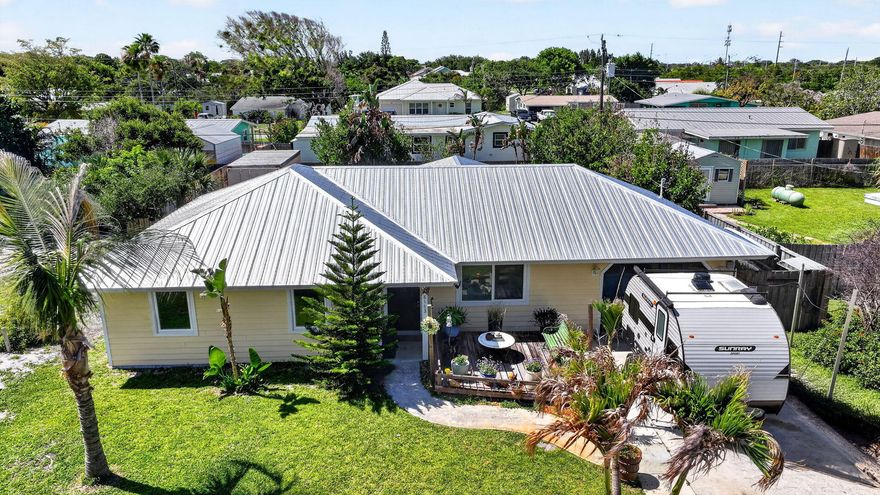 Lovely coastal retreat, offering two bedrooms two baths approximately 1560 under air. Impact glass Windows. Recent improvements include a brand new roof 2026, new hot water heater 2026, new refrigerator, new washing machine. A spacious dining room addition creates the perfect gathering space for dinners and entertaining guests. Step outside to the generously sized backyard featuring beautiful paver area IDEAL for outdoor entertaining, relaxing or enjoying the Florida sunshine. Enjoy the charming orchid Hut, creating a peaceful garden retreat with a tropical feel. Conveniently located close to shopping, dining, Beautiful Hobe Sound beaches, and all the amazing amenities it has to offer. Showing as a two bedroom two bath can be converted back to a three bedroom. One of the Properties standout features is the fully permitted insulated shipping container/man cave 8 x 20 complete with air conditioning available as an optional purchase IDEAL for workshop, hobby room, studio, storage or ultimate game-day retreat.