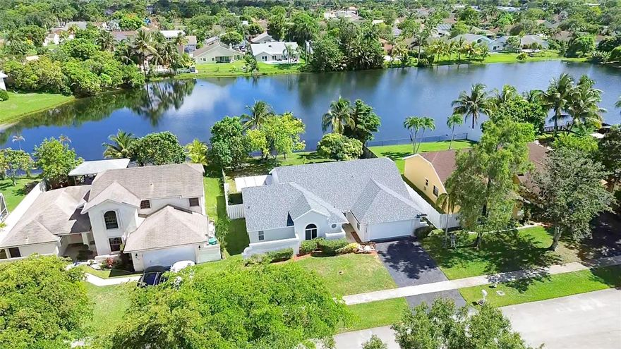 Welcome to your new lakefront oasis in the heart of South Florida! Wake up to serene lake views and enjoy your morning coffee in the spacious backyard surrounded by nature, fruit trees, and exotic wildlife. This 4-bed, 3-full bath house offers an open floor plan with high vaulted ceilings and recently renovated bathrooms, showers, and kitchen cabinets. This home is move-in ready with major upgrades already done for you — including 2024 impact windows and doors, 2024 roof, and a 2025 central AC system. Conveniently located between Sawgrass Expressway and the Florida Turnpike, you’re just minutes from major roads, beaches, airports, and cities. Schedule a showing today to make this beautiful house your new home and experience South Florida living at its finest!
