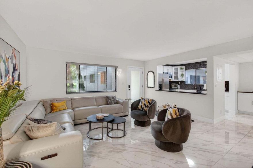 Exquisitely renovated 2BR/2BA condo in the vibrant 55+ gated community of Lakes of Delray. This elegant home features a NEW open kitchen with SS appliances and granite counters, NEW bathrooms, full-size washer/dryer, and two walk-in California closets. The Florida room offers impact Glass sliders looking on a serene lake. Enjoy a fabulous social life in this resort-style community with a clubhouse, theater, pools, fitness center, tennis, pickleball, billiards, social clubs, and organized outings. Ideally located near W Atlantic Ave dining, entertainment, and Delray's beautiful beaches. Cable & Internet included. INVESTOR - Rent Right Away - Once per year.