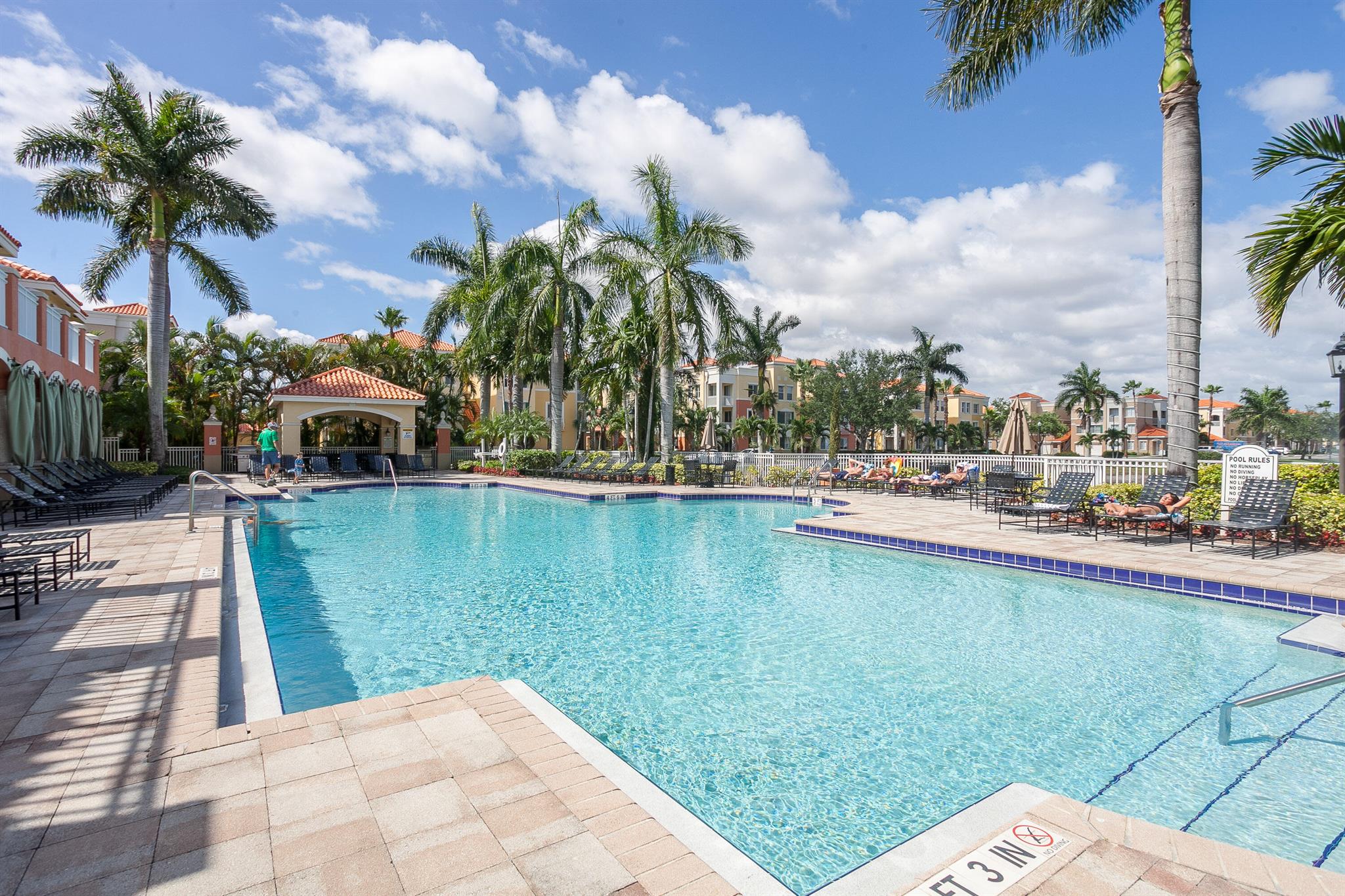 Enjoy resort style living in this luxury gated community in the heart of Palm Beach Gardens. Freshly painted 3 bedroom/2-bathroom unit with features that include: an open kitchen with s/s appliances, white cabinets, full-size washer/dryer, new custom vinyl flooring throughout, new lighting and fans. Enjoy the lush tropical landscape from your private balcony. Addt'l features include a community pool and spa, fitness center, tennis courts and clubhouse with built-in grills. It is walking distance to shops and restaurants and conveniently located near the Gardens Mall and I-95. Pets welcome! Water included and two assigned parking spaces. ANNUAL RENTAL ONLY.