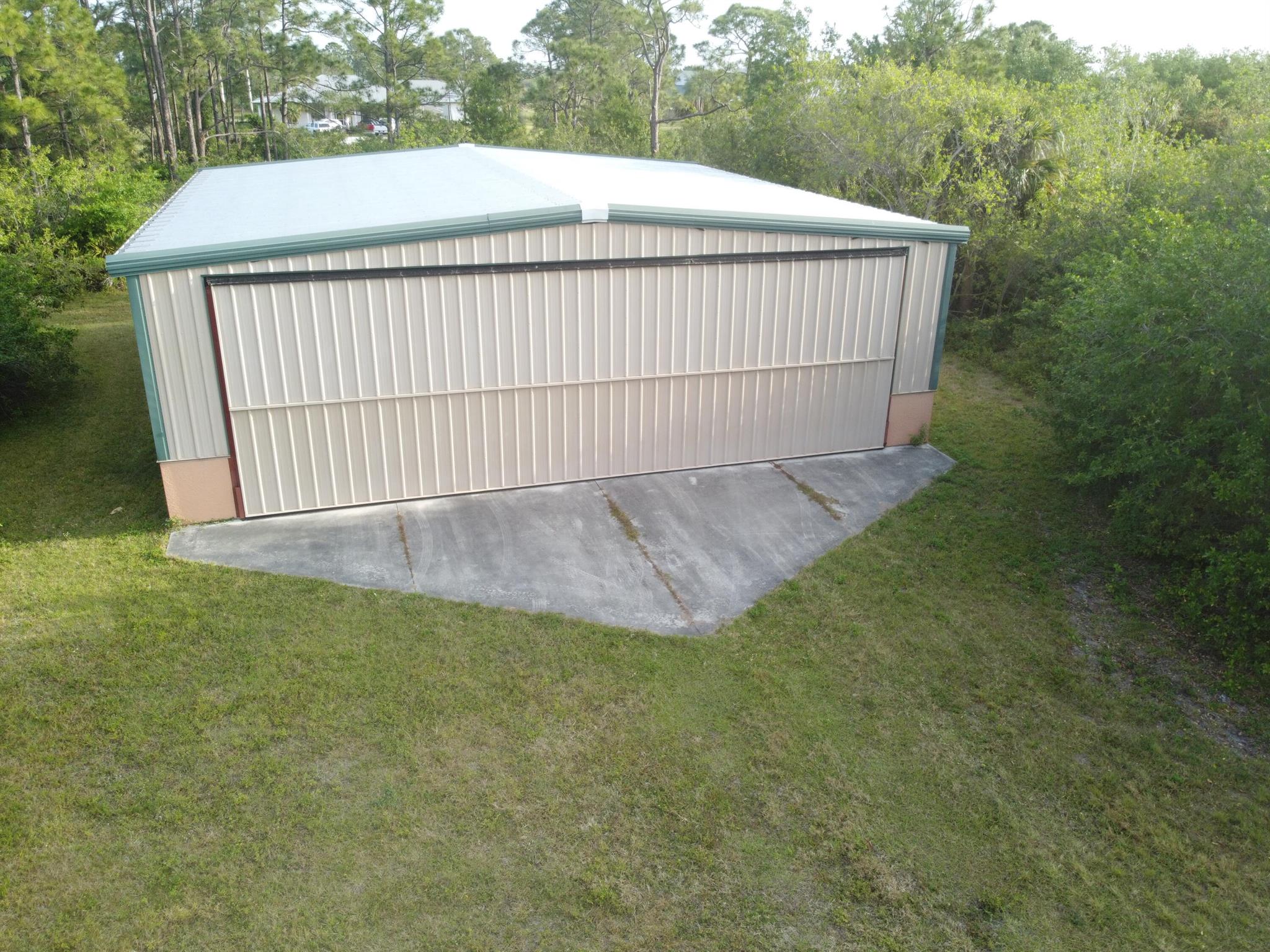LOWEST PRICED AIRPARK PROP W/HANGAR IN SOFLA. TREASURE COAST AIRPARK (FL37) OFFERS THE NEWEST RUNWAY IN SOUTH FLORIDA. 10-28 IS NEWLY (2023) PAVED W/ RUNWAY EDGE LIGHTING. AT 4067' X 48' 10-28 WILL ACCOMMODATE MOST AIRCRAFT UP TO 12,500LBS. TCA (FL37) SITS IN CLASS G UNDER CLASS E SHELF. BEST OF ALL, TCA IS NOT IMPACTED BY TFR'S BY 47. CONVENIENTLY SITUATED OFF WALDO PEPPER WITH DRIVEWAY ACCESS OFF CRUSADER AND JUST A FEW FEET OFF AND WITH STRAIGHT ACCESS TO THE EAST END OF THE RUNWAY. 2.57 ACRE TREE LINED LOT IS AIRCRAFT READY WITH A 2500SQ FT 2012 HANGER (50'X50') 140MPH WIND RATED, 42' X 12' OPENING w/ SCHWEISS BI-FOLD DOOR. BUILT 2' ABOVE THE ROAD CROWN W/ A 48'' CBS STEM WALL FOR ADDED PROTECTION AGAINST THE ELEMENTS. INSULATED ROOF & FLUORESCENT LIGHTS BRINGS DAYLIGHT INSIDE