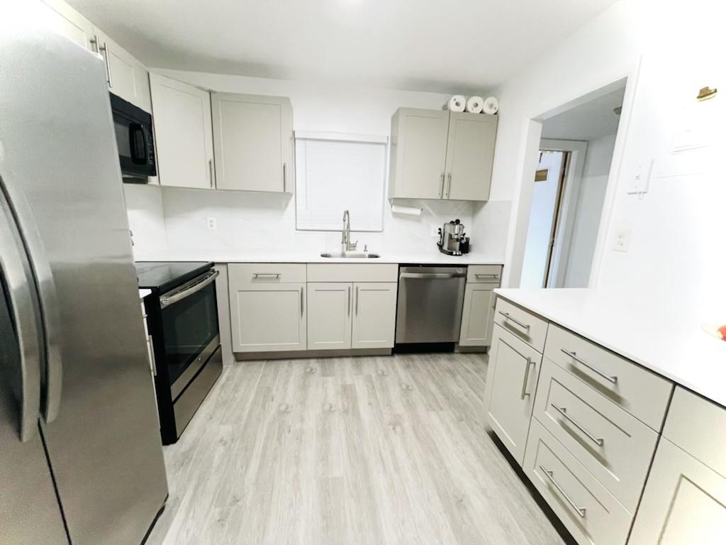 Located in a perfect spot with an easy commute to major roadways. Quick access to entertainment, the Hard Rock Casino, beaches and more. End unit on the ground floor with an enclosed patio with hurricane impact glass. The view of a lush, tropical paradise with a tranquil fountain. Updated top to bottom, this modern, designer condo unit is ready for the most discerning buyer. Inside the unit, quartz counters, custom cabinetry and newer appliances. Waterproof luxury vinyl floors. Modern design with every detail already taken care of for you. Can be rented right away. Less than a mile to houses of worship. Furniture is negotiable.
