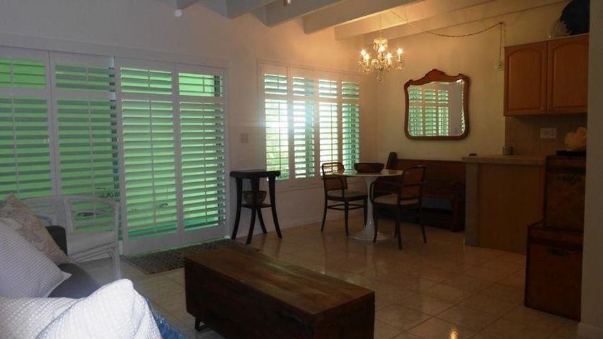 Located on ground floor, this move-in condition unit is tucked away for lots of privacy & easy access.  Partially upgraded and flooring completely tiled, new plantation shutters and accordian shutters, central air has been maintained & ducts sanitized with UV light protection. 2 Ceiling fans & exposed  wood beam ceiling.  This Historical building is found in the Historical District of the Parrott Cove area & within walking distance to the LW Golf Course & Clubhouse with great restaurant on the Intracoastal.  Just a hop, skip & jump to the fabulous LW Beach with restaurants & shops & of course the Atlantic Ocean & Pier.  Walk or short bike ride to all the fun activities & shopping,   Pet up to 45 lbs allowed.  This is an adult community with flexible age restrictions.