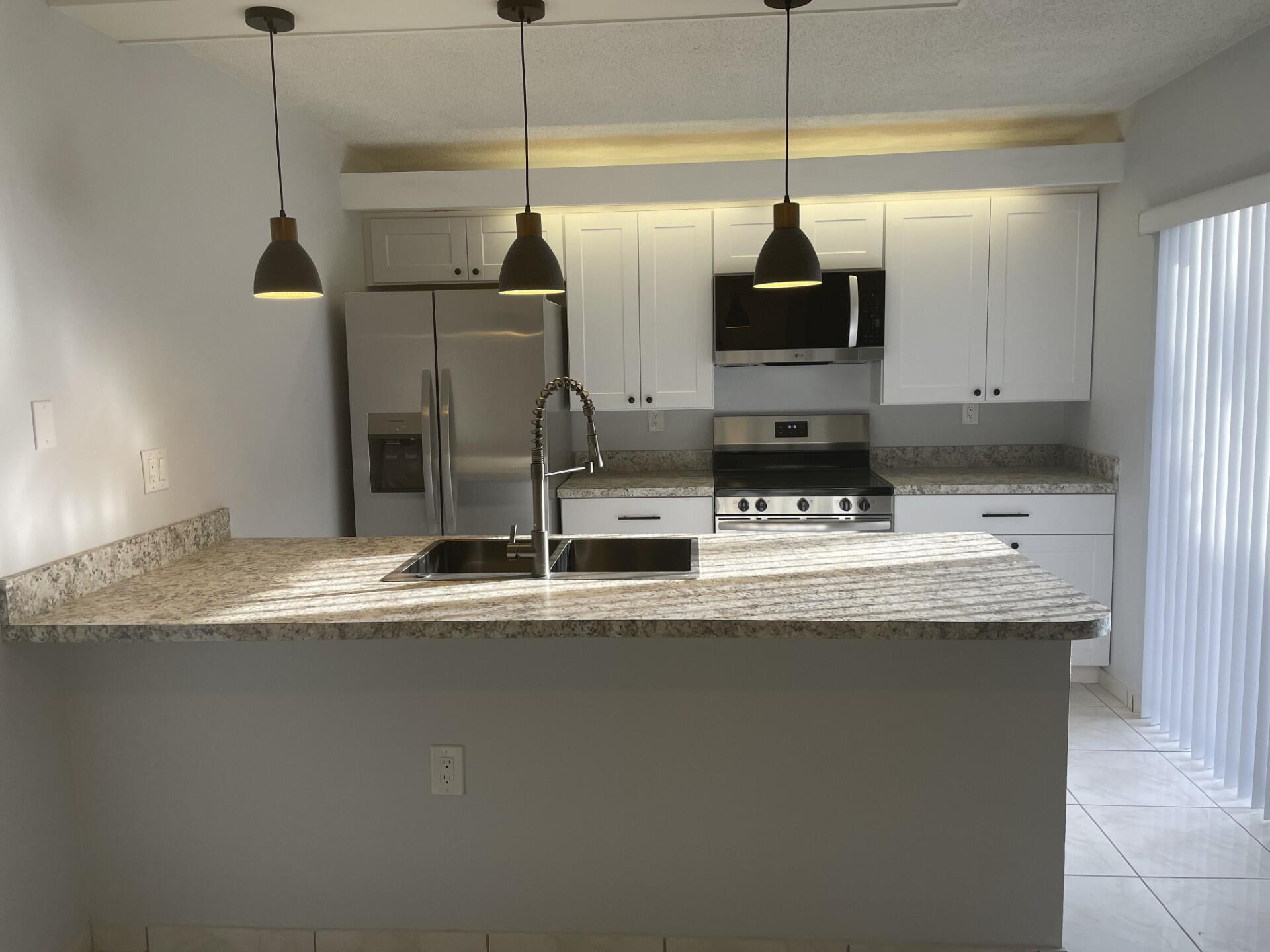 Beautifully renovated 2 story townhome ready for move in!!! Kitchen, living, laundry , 1/2 bath on ground floor Second floor has 2 large bedrooms with its own bath and large closets. Best part of the unit is the huge back patio and the large yard facing tree lined streets etc.