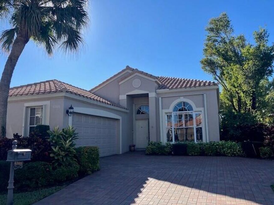 Enjoy amazing sunrise views over the lake from your own tropical oasis.  The patio has two electric awnings with lights making it easy to relax outside even on those super-sunny days and at dusk.  Light-filled one-story home with 3 bedrooms 2 baths and a 2-car garage.  Plantation Shutters throughout.  Quartz counters in kitchen.  Beautiful remodeled baths.  Hurricane resistant garage door and Accordion Shutters throughout.  Roof 2009.  Solar hot water heater and solar panels 2009.  Brick paver driveway 2009.  Situated in the only non-gated community in Boca Pointe, Palladium has just 35 homes.  Residents enjoy a low-maintenance lifestyle.  Included in the low monthly HOA is lawn care and roving security.