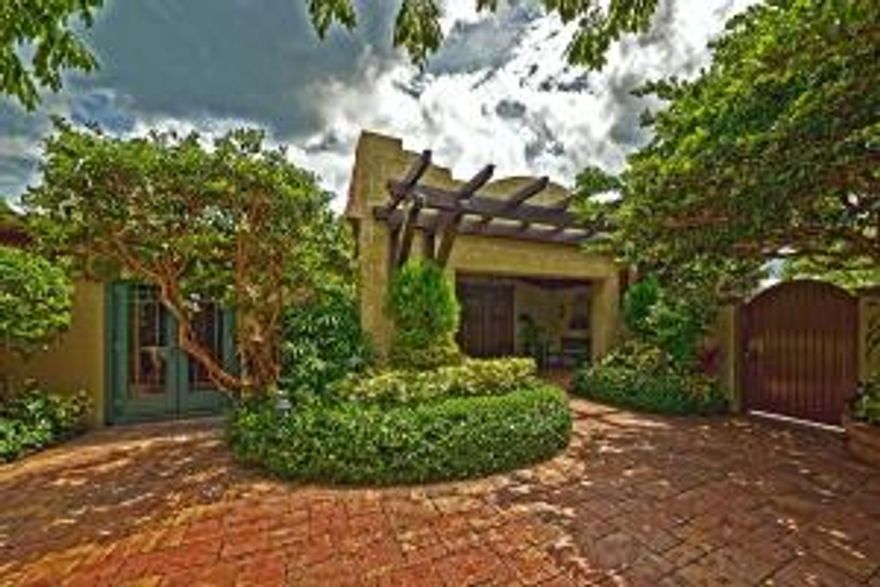 Tropical Waterfront Oasis, a true boater's dream home! 75 feet directly on deep water canal just a few homes off the Intracoastal. Boat dock with lift, water & electric. Own your own piece of paradise with this amazing and quietly spectacular 3BR/4BTH residence, garage and pool. Gas lanterns welcome guest into the walled courtyard entrance patio w/gas fireplace & covered front portico. Warmth and privacy is the theme throughout. Cathedral, wood beamed ceilings, wide planked and pegged floors combining phenomenal open spaces with panoramic water views. An exquisite ''French Country'' kitchen, farmer's sink, island, 6 burner wolf stove and custom glazed wood cabinetry. Fireplace in dining room w/French doors leading to alfresco covered patio. Luxurious master suite plus, plus, plus!