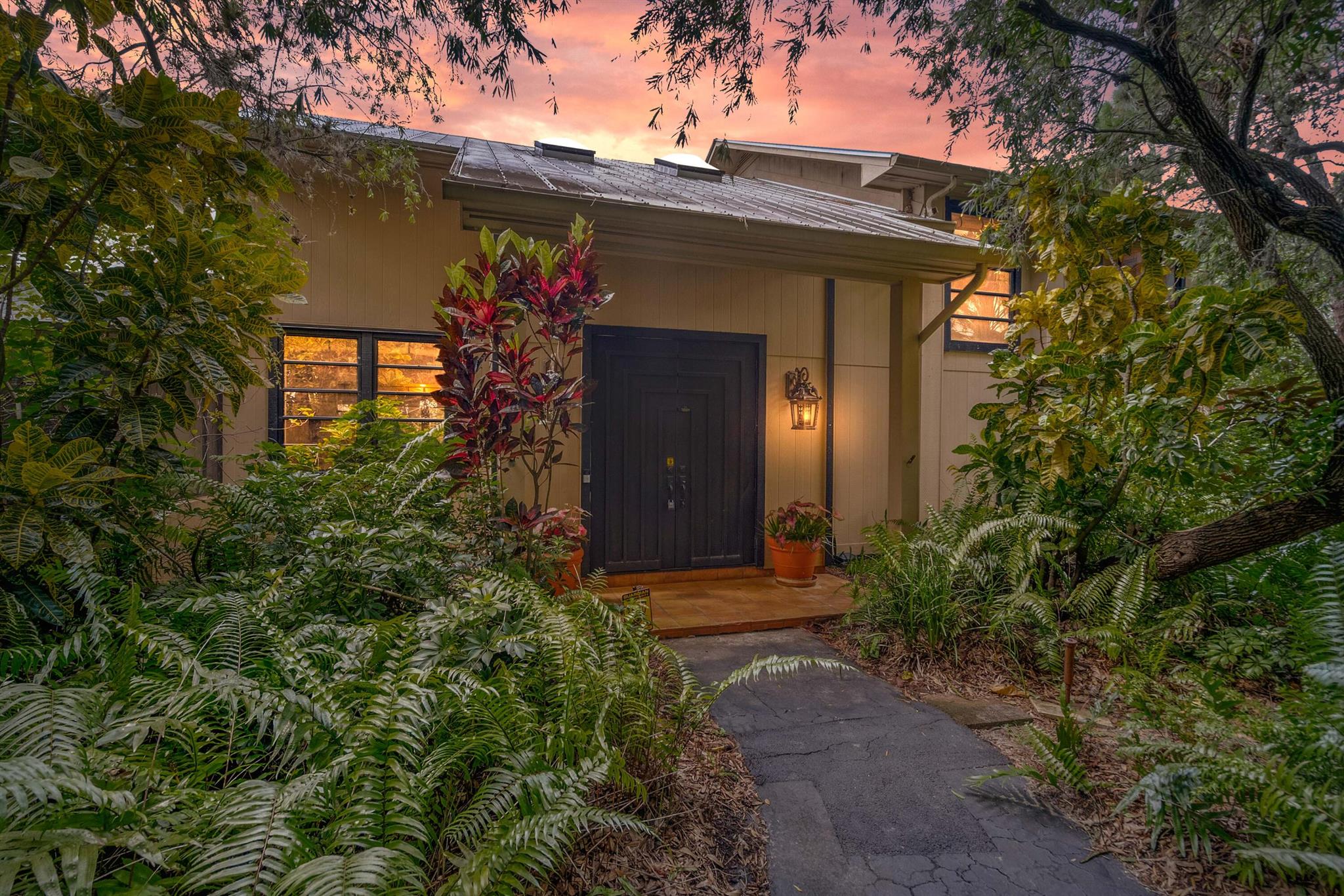Luxurious 5BR/3BA Pool Home on 1+ Acre with Marina Slip. Rarely available Wide Waters estate backs to the Floridian Golf Club. Custom KraftMaid kitchen with stainless backsplash, pull-outs, and herbarium. Grand staircase leads to the owner's suite with a Kohler Watersilk Whirlpool, twin vanities, and walk-in shower with dual showerheads. The outdoor living space is an entertainer's dream, featuring a 50-foot screened lap pool, expansive covered porch, and a custom 32-foot-wide pocket sliding door that blends indoor and outdoor living seamlessly. Includes a home office with built-in desk and shelves (BR 3), mother-in-law suite (BRs 4 & 5), and slip #14 in marina for river/ocean access.
