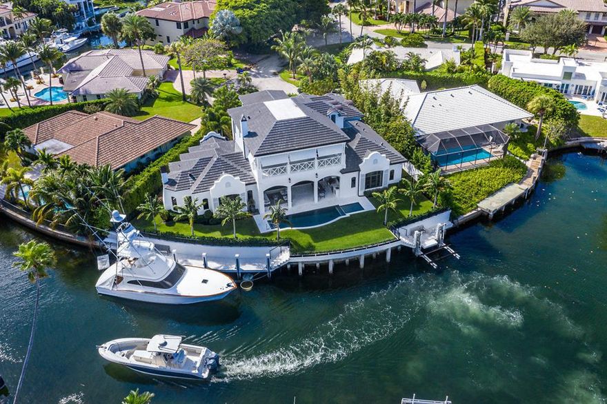 Imagine yourself living in this immaculate 137' point lot estate in quintessential Boca Raton seaside enclave, Sun & Surf. Two fully equipped docks accommodate a 70' vessel & a 40' boat on Neptune elevator lift. Unmatched view on wide crystal clear turning basin - you're certain to spot sea turtles. Completed in 11/2017, no expense was spared, no detail overlooked in the residence. Designer finishes include Walker Zanger tile, RH and Newport Brass fixtures and a true gourmet kitchen. Private entrance guest suite, sequestered master, and all en-suite bedrooms. Full CBS construction, poured concrete second floor, best-in-class CGI impact windows, entire loggia opens via Euro-Wall accordion impact windows onto summer kitchen and outdoor living are enclosed with concealed electric screen.