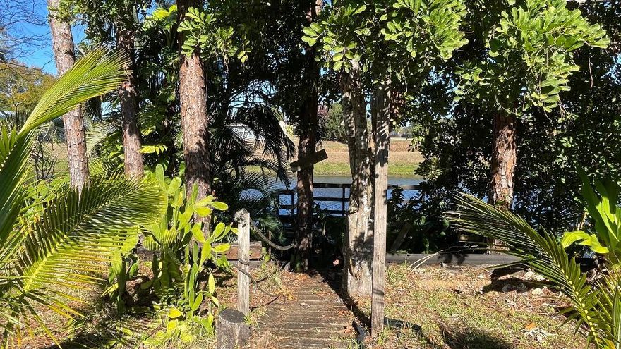 Waterfront Hidden Gem on a 0.32 of an acre oversize corner lot, 3/2/2 cbs inground pool-spa home, new roof 2023 with new fascia and gutters, impact windows, 2 sheds, fruit trees. Granite kitchen counters, beautiful and working  stone fireplace. Wood and laminate floors. Bring your fishing rods, owner says good fishing from your own wood dock.
Enjoy the nice pool and spa while barbeque