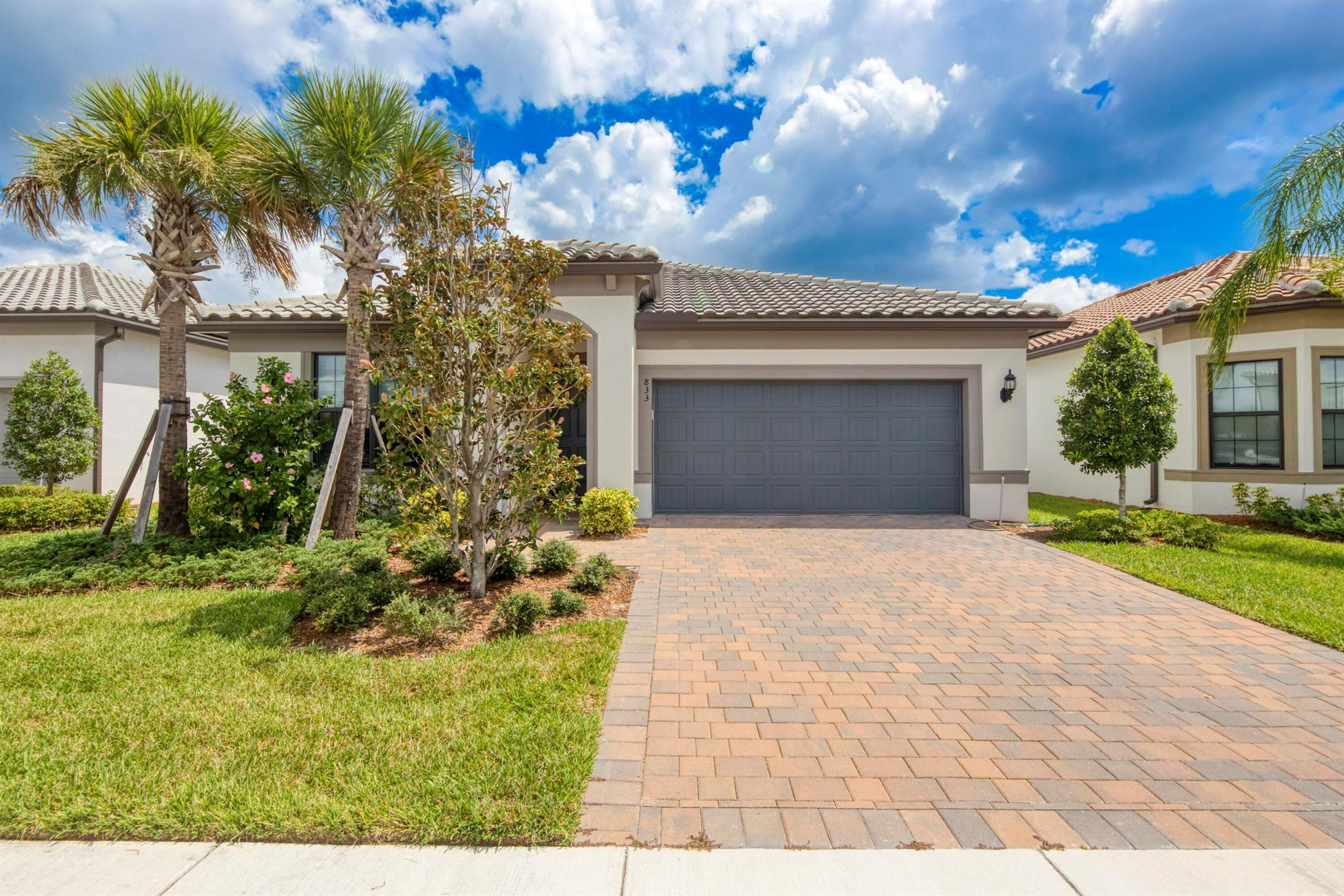 Welcome to this stunning 2023 Divosta 4-bedroom, 2-bath home in the highly desirable Veranda Gardens of Port Saint Lucie! The heart of the home is the bright white chef's kitchen, complete with a gas range, wall oven, and gas water heater, perfect for cooking and entertaining. Enjoy a peek-a-boo lake view from the backyard and experience family-friendly living at its finest with resort-style amenities including a sparkling pool, private clubhouse rooms for gatherings, an outdoor bar, and a cozy bonfire area for cool Florida nights. This home offers the perfect blend of elegance, comfort, and community living!