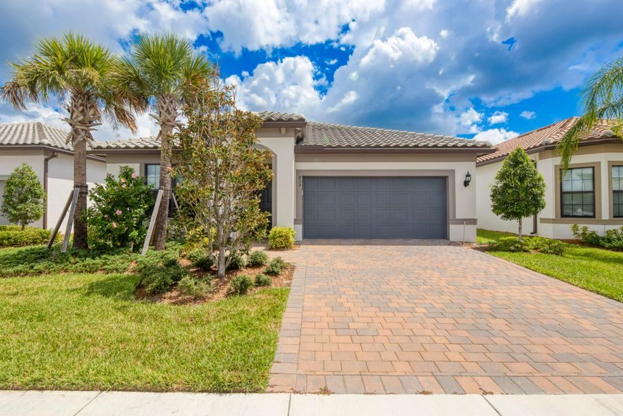 Welcome to this stunning 2023 Divosta 4-bedroom, 2-bath home in the highly desirable Veranda Gardens of Port Saint Lucie! The heart of the home is the bright white chef's kitchen, complete with a gas range and gas water heater, perfect for cooking and entertaining. Enjoy a peek-a-boo lake view from the backyard and experience family-friendly living at its finest with resort-style amenities including a sparkling pool, private clubhouse rooms for gatherings, an outdoor bar, and a cozy bonfire area for cool Florida nights. This home offers the perfect blend of elegance, comfort, and community living!