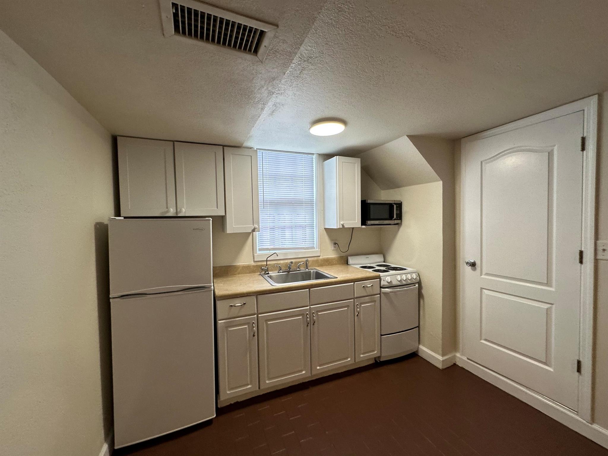 Charming 1 bedroom/1bath apartment offering painted brick flooring, kitchenette, and freshly painted walls. Located on the ground floor with large open patio and common outdoor sitting area. Rent includes water, electricity and access to coin laundry shared with other tenants. Located on one of Lake Park's premier streets and a few blocks from the Intracoastal Waterway. First, last, security, sufficient income, and good credit.