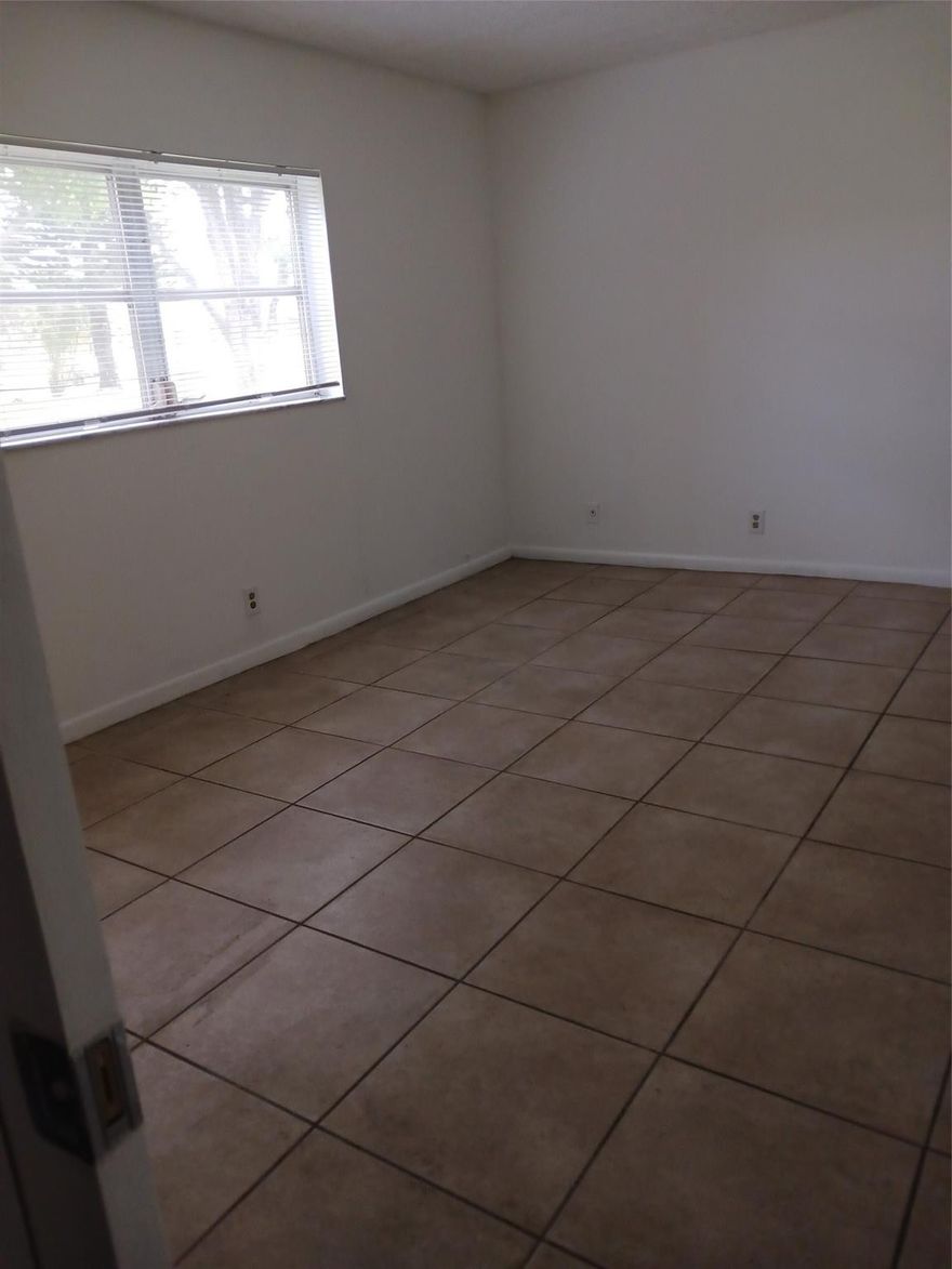 Oriole gardens phase ONE---- 55 plus community ( unit is wheelchair accessible) - NEWLY REFRESHED-All white kitchen- 2/2 ground floor- newer a/c - neutral ceramic tile throughout the entire unit. screened patio with hurricane shutters- great location across from a shopping center and near bus stop to the beach and mall. Can be rented after owning it for 3 years  new buyers can have 1 car only and at least a 675 credit score