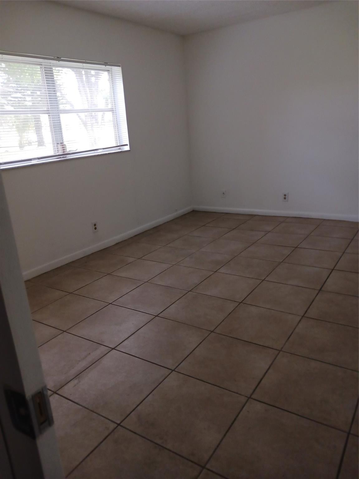 Oriole gardens phase ONE---- 55 plus community ( unit is wheelchair accessible) - NEWLY REFRESHED-All white kitchen- 2/2 ground floor- newer a/c - neutral ceramic tile throughout the entire unit. screened patio with hurricane shutters- great location across from a shopping center and near bus stop to the beach and mall. Can be rented after owning it for 3 years new buyers can have 1 car only and at least a 675 credit score