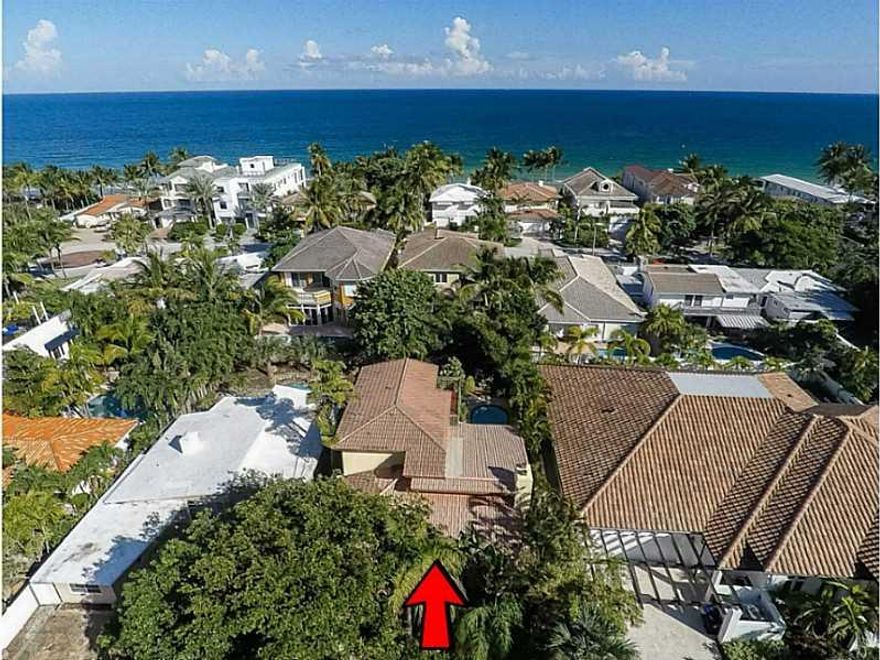 A taste of Key West in Ft Lauderdale. Steps to the beach. Enter this gem into an open 2 story great room that flows through to the pool and backyard with truly a tropical island resort-like feel. Many architectural design features: vaulted and beamed ceil ings, 2 fireplaces, terracotta and Dade county pine floors.  The Caligaris kitchen adds a modern element feeling featuring stainless Kuppersbusch and LG appliances. Spacious master with a wraparound terrace and an "ocean peek" view. Updated baths. Office