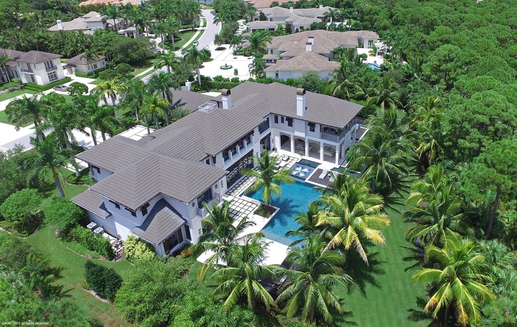 Stunning Custom Estate residence on desirable one acre home site with private preserve and golf views. This incredible home boasts an open great room plan, light and bright kitchen with an gorgeous salt water aquarium and breakfast area; club room with video game center and theater room, wine tasting area with fireplace and custom built ins, 2 offices (his and her's), elevator, 2 separate stairways; expansive 2nd floor master suite with his and her bathrooms and covered terrace with a beautiful view of the golf course. The backyard is perfect for entertaining or relaxing in paradise and show cases lush tropical landscaping, outdoor fire place, summer kitchen, covered lanai, resort like pool with fire bowls and water features. Make this lavish resort style home yours today!