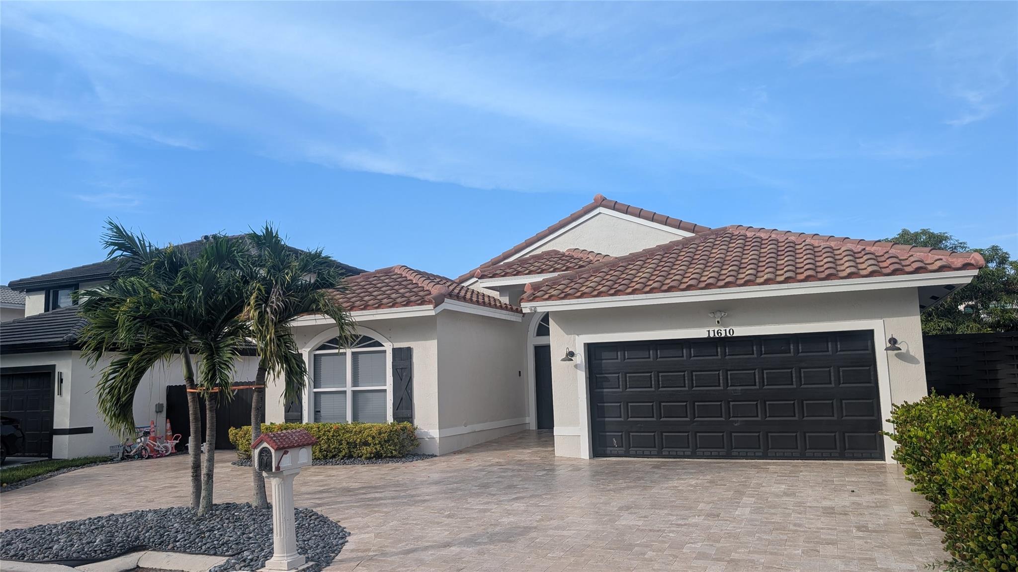 This beautifully remodeled 3-bedroom, 2-bathroom home offers the best of South Florida living, perfectly situated on a scenic canal. Step inside to discover a bright and open floor plan, meticulously updated with modern finishes throughout. The heart of this home is truly the backyard oasis, designed for ultimate relaxation and entertaining. Enjoy a refreshing dip in the sparkling pool, or unwind under one of the two charming tiki huts. One of the tiki huts is equipped with electrical hookups, perfect for entertainment system, or additional lighting. Brand new impact windows being installed any day! The exterior boasts a spacious circular driveway providing ample parking for guests, and a convenient storage shed on the side of the house for all your outdoor gear and tools.