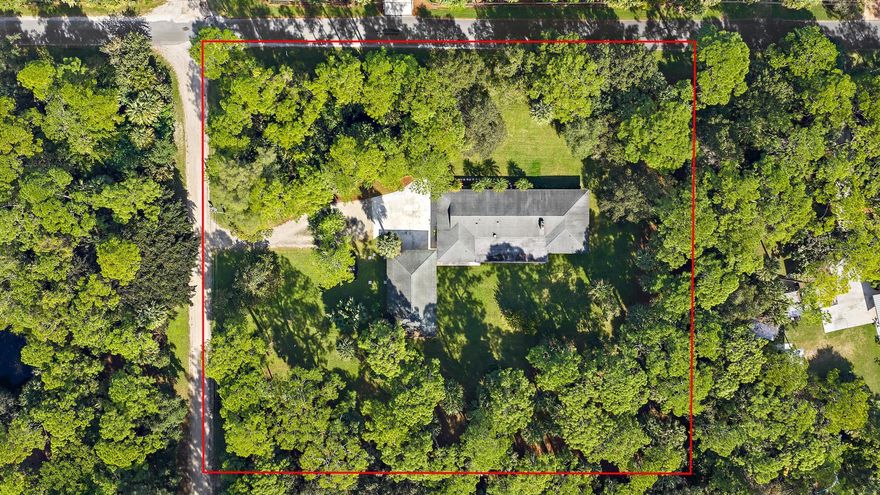 Discover the best of Jupiter Farms living on this 2.5-acre high-and-dry corner lot on the desirable east side of the community. This well-maintained CBS home offers 4 bedrooms, 3 baths, an attached 2-car garage, and over 2,400 sf of living space. The functional layout includes a large screened patio and provides a great opportunity for contemporary updates. Separate from the main home, the 23' x 47' CBS detached garage/workshop is equipped with water and power and offers ample height for a lift. It's ideal for car enthusiasts, hobbyists, or could be converted into additional living space. Located on a paved road. Enjoy the quiet, peaceful setting while still being close to all the conveniences of Jupiter. Roof 2016. Professional photos coming soon.