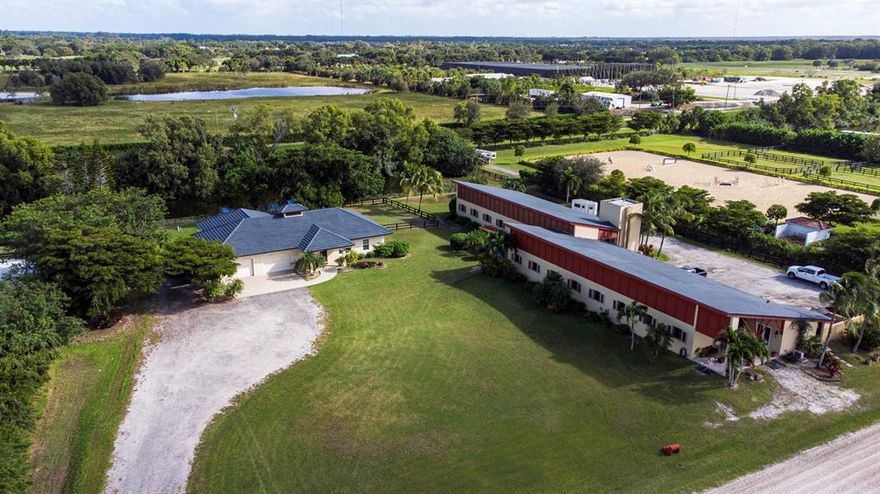 Reduced $295,000! Must Sell! Lovely contemporary stable with 25 stalls in two separate isle-ways providing privacy for the owner away from boarders, an ideal income producing property. There are 2 feed rooms, 2 tack rooms, 6 large grass paddocks and irrigated arena. The property also boasts a 3Br/2Bth home perfect for staff with office space, 2 car garage and covered patio. Other features include: two gated entries, fly spray system, cedar lined tack rooms, 2 wash racks and studio apartment. The property is situated in one of Wellington's finest equestrian subdivisions with quick and easy access to WEF & Global.