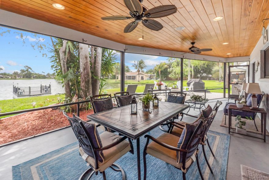 Welcome to this beautifully maintained 3-bedroom, 2-bath single-family home in Huntington Woods, one of Royal Palm Beach's most desirable communities.  Lovingly cared for by its original owners for over 40 years, this home sits on an oversized 0.23-acre lakefront lot and offers a long, tranquil water view, a private dock with electric and running water already in place, plus durable, weatherproof decking for low-maintenance enjoyment. There is also plenty of room to add a pool and create your dream backyard oasis.  Inside, you'll find a warm and inviting layout featuring a real wood-burning fireplace, a custom kitchen with solid wood cabinetry, quartz countertops, and stainless steel appliances, along with walk-in closets in every bedroom complete with built-in shelving for exceptional storage and organization.  The spacious screened-in patio overlooks the lake and provides the perfect setting to relax or entertain while enjoying the peaceful surroundings.  Additional highlights include impact windows throughout (with shutters for the rear sliders), an impact-rated front door and garage door, a 2023 water heater, a 2024 HVAC system, and exterior security cameras.  Huntington Woods is known for its charm, convenience, and incredibly low HOA of just $28 per month, all while being close to top-rated schools, shopping, dining, and everything Royal Palm Beach has to offer.  Don't miss this rare opportunity to own a true lakefront home in an exceptional location. Schedule your private showing today!