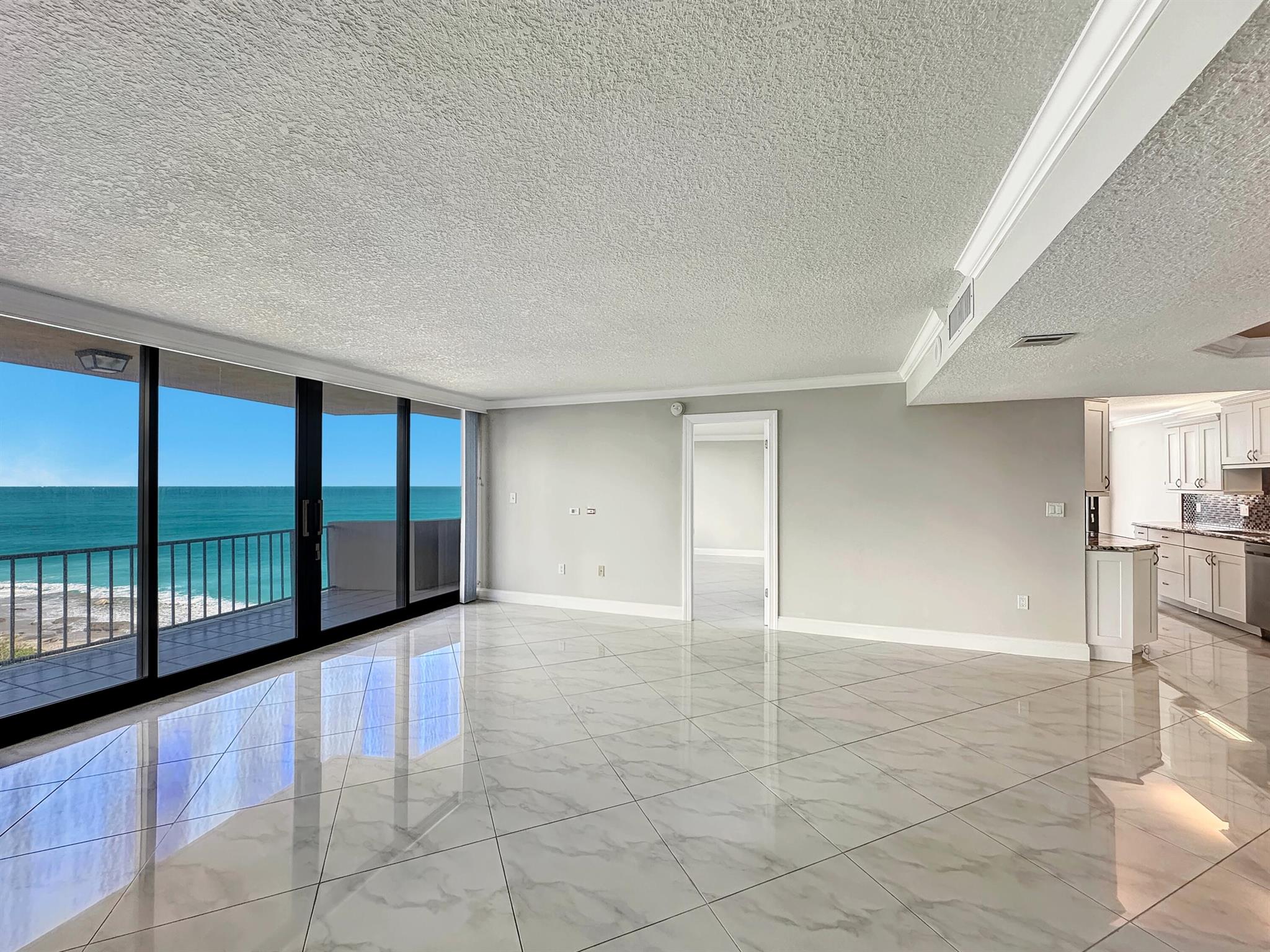 It's all about the views - enjoy the crystal blue ocean from every room in this front corner unit. The 2BR / 2BA split BR plan features a neutral color palette & polished ceramic tile throughout. Updated kitchen w/ granite counters, stylish backsplash & stainless appliances. Small nook off kitchen opens on to the balcony & overlooks the Atlantic - perfect location for morning coffee or cocktails. Large laundry room w/ washer dryer inside unit. Impact sliders throughout. Cote D'Azur has fob access to front gate & each tower. On-site manager M-F. Pool, grills & large outdoor social area between the two towers. Gym, community room, library & tennis and pickleball courts. 15 minutes to world class shopping, dining.