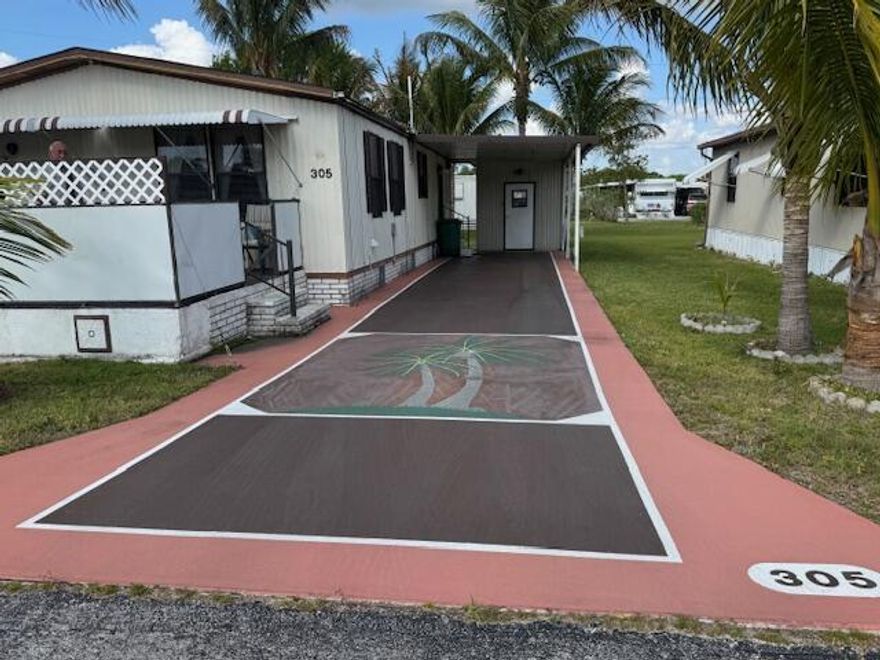 Welcome Home to $0 LOT LEASE, & only $250 monthly fees, for this lovely manufactured home in the Whispering Creek 55+, CO-OP community. The spcacious, well maintained home is turn-key ready, and rests on an oversized lot, minutes from the blue water beaches of Ft Pierce, & surrounded by beautiful, mature swaying palm trees. The sizeable 2 Bdr- 2 Ba. boasts indoor laundry, an extended carport, a handy storage shed, and rests directly across from a peaceful common green space, with no neighbors to the east. You'll love the beaurtiful balmy breeze and extra privacy from your custom glider on the lovely oversized porch. An additional bonus... engineered hurricane anchors & concrete footings (some over 1000 lbs) secured by 19 additional stabalizing lines for enhanced storm protection!