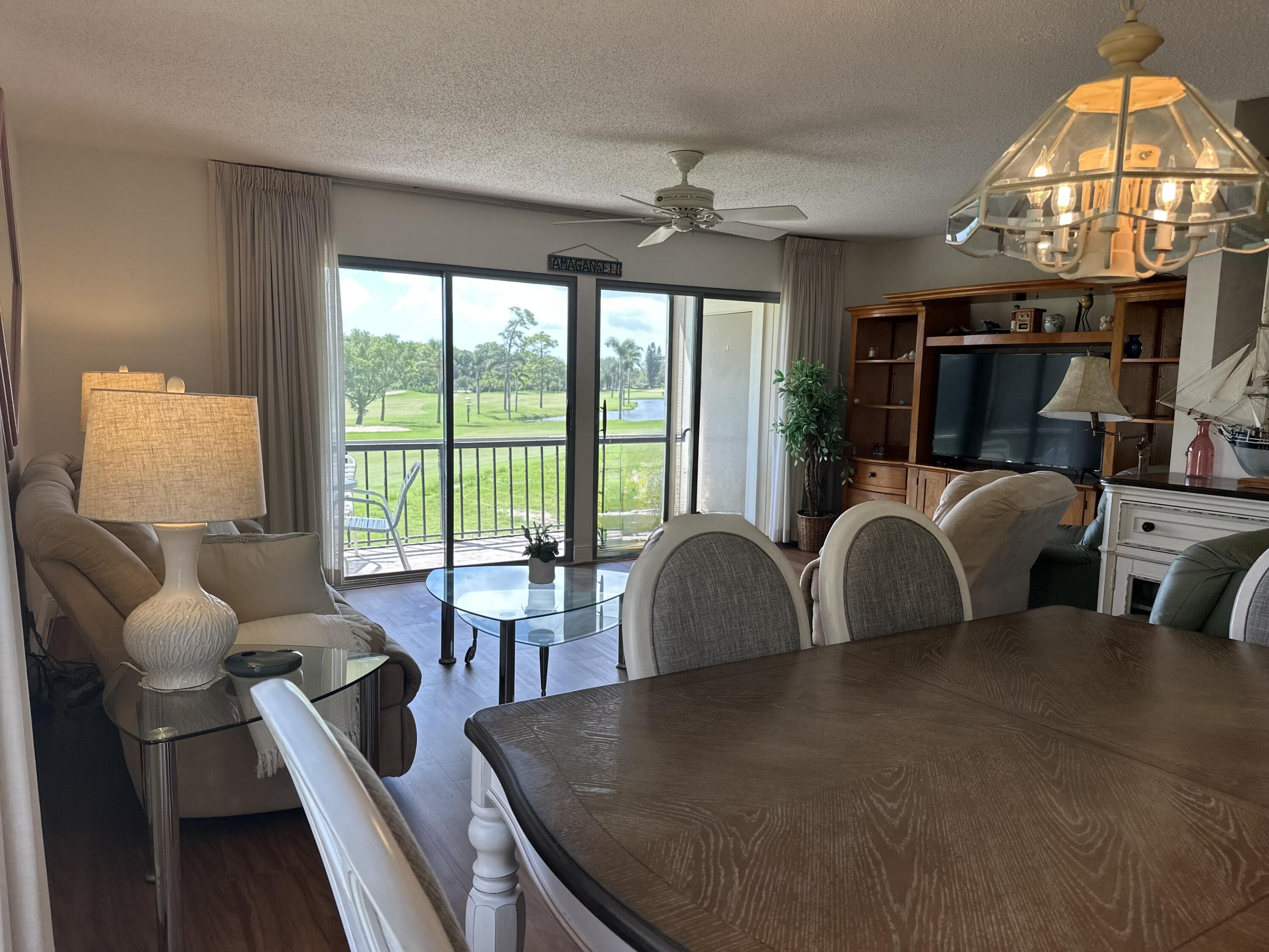 Welcome to luxury living at Riverbend Country Club! This exquisite 2-bedroom, 2.5-bathroom condo offers a perfect blend of comfort and elegance with stunning sunrise views of hole #15 and a large picturesque lake. Immerse yourself in the serene beauty of Riverbend's private golf course, designed by Tom Fazio, often hailed as the ''Jewel of the Loxahatchee.'' As you step into this meticulously maintained residence, you'll be greeted by breathtaking views. The spacious balconies, beckon you to unwind and soak in the natural beauty that surrounds. The living and dining areas feature brand new